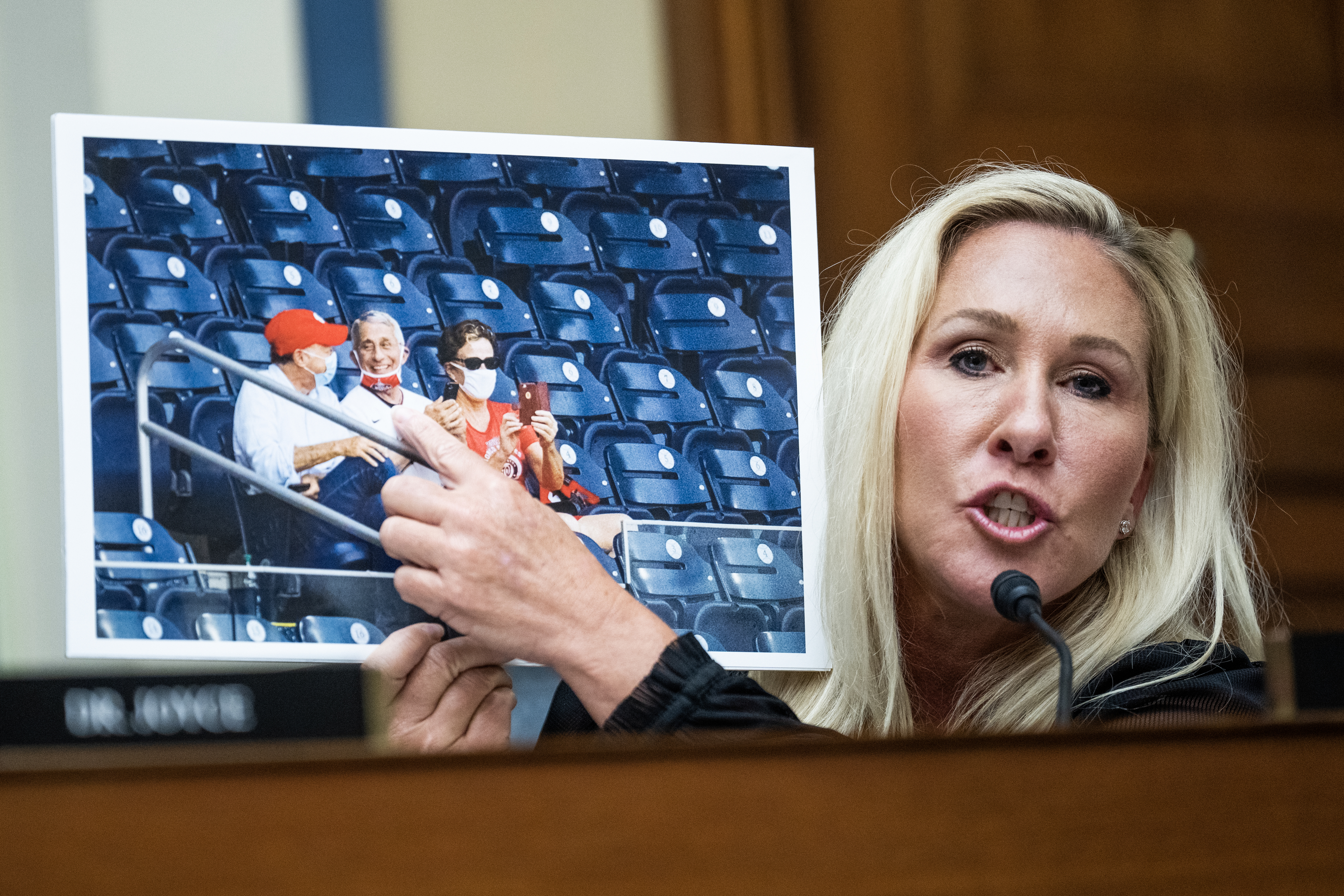 Marjorie Taylor Greene presents a photo of President Joe Biden and Anthony Fauci sitting in a stadium during a congressional hearing