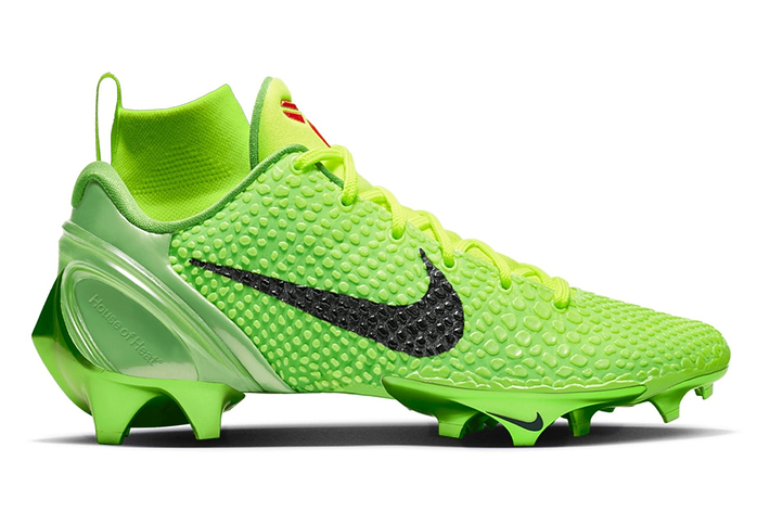 A lime green Nike soccer cleat with a textured upper, featuring a black Nike swoosh and innovative stud design