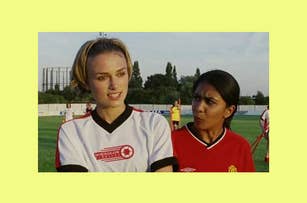 Keira Knightley and Parminder Nagra wearing soccer uniforms, standing on a soccer field, appearing to be mid-conversation