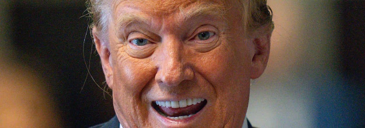 Donald Trump smiling while wearing a suit