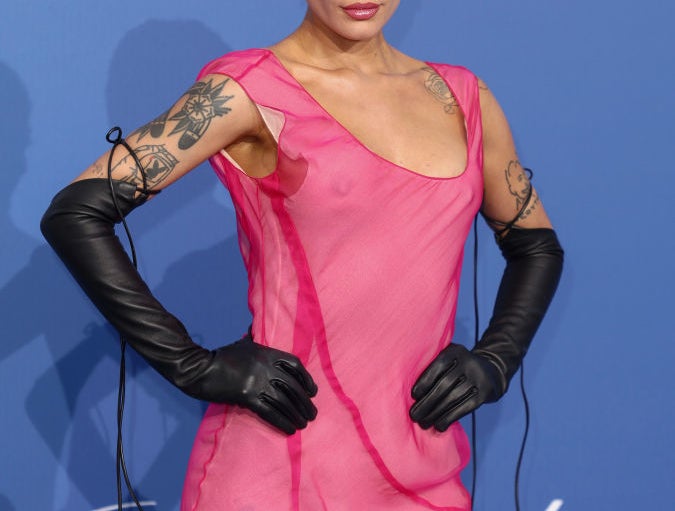 Halsey on the red carpet wearing a sheer, fitted dress with long gloves