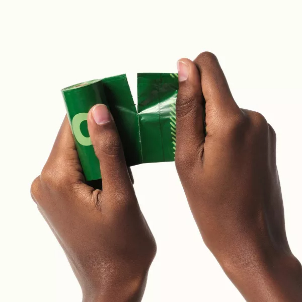 Two hands tearing open a bag