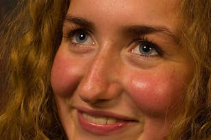 Close-up image of a person with curly hair smiling and looking upwards. The article is categorized as Internet Finds