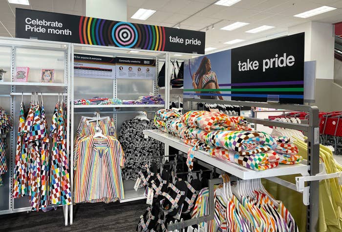 Store display promoting Pride Month features colorful, patterned clothing and accessories with &quot;Celebrate Pride month&quot; and &quot;take pride&quot; signage