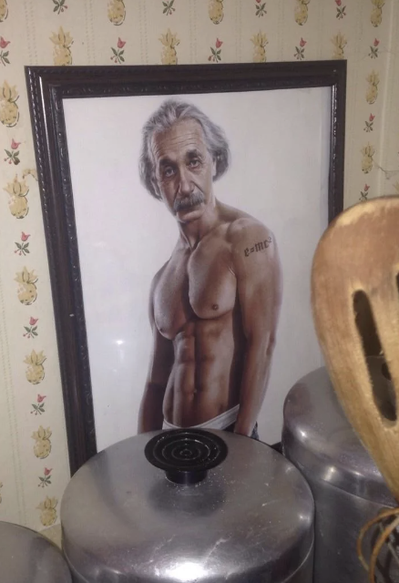 Painting of a muscular, shirtless older man with gray hair and a mustache, posing with a tattoo on his arm, surrounded by kitchen canisters