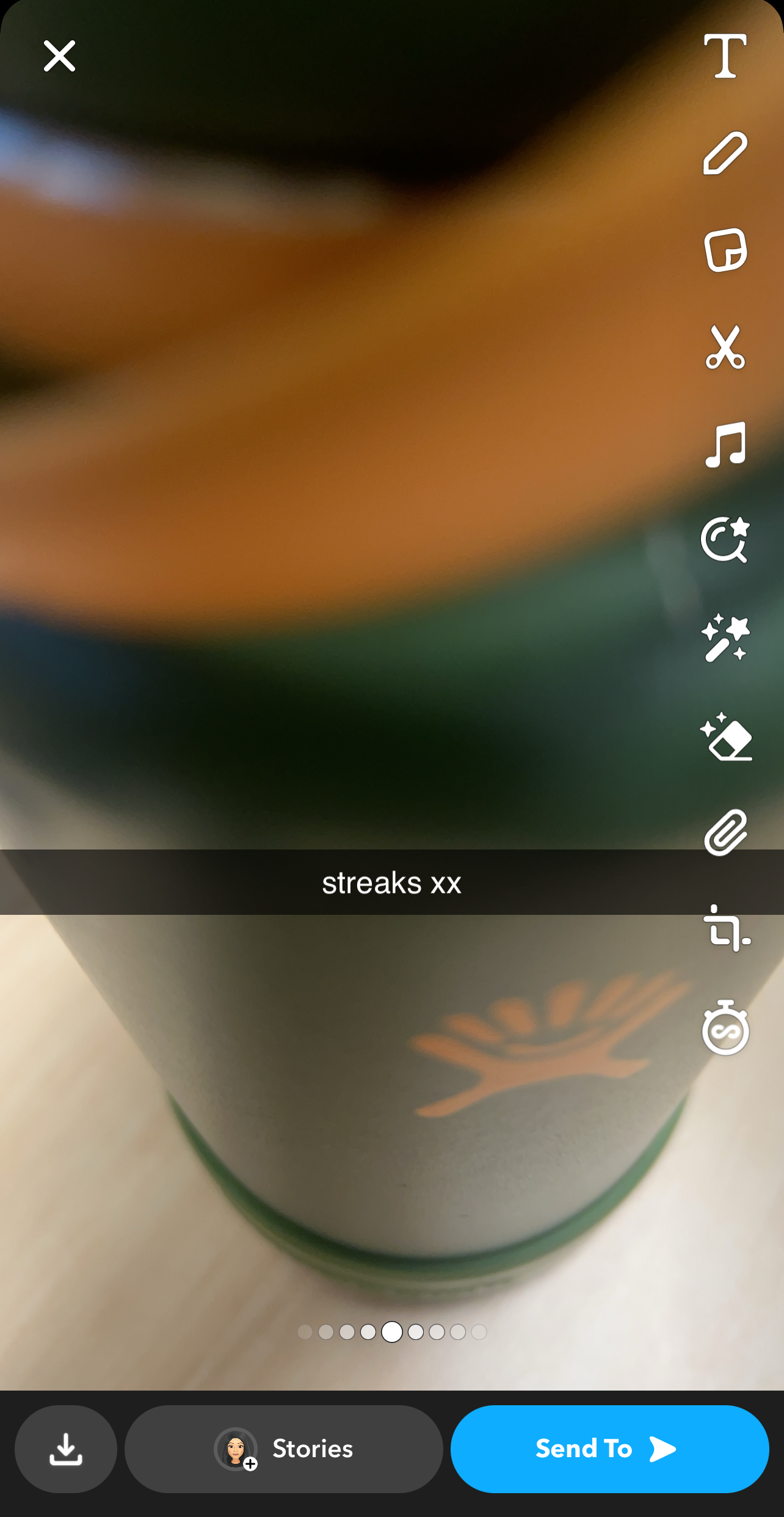 Close-up image of a green bottle with a Snapchat caption saying &quot;streaks xx.&quot;