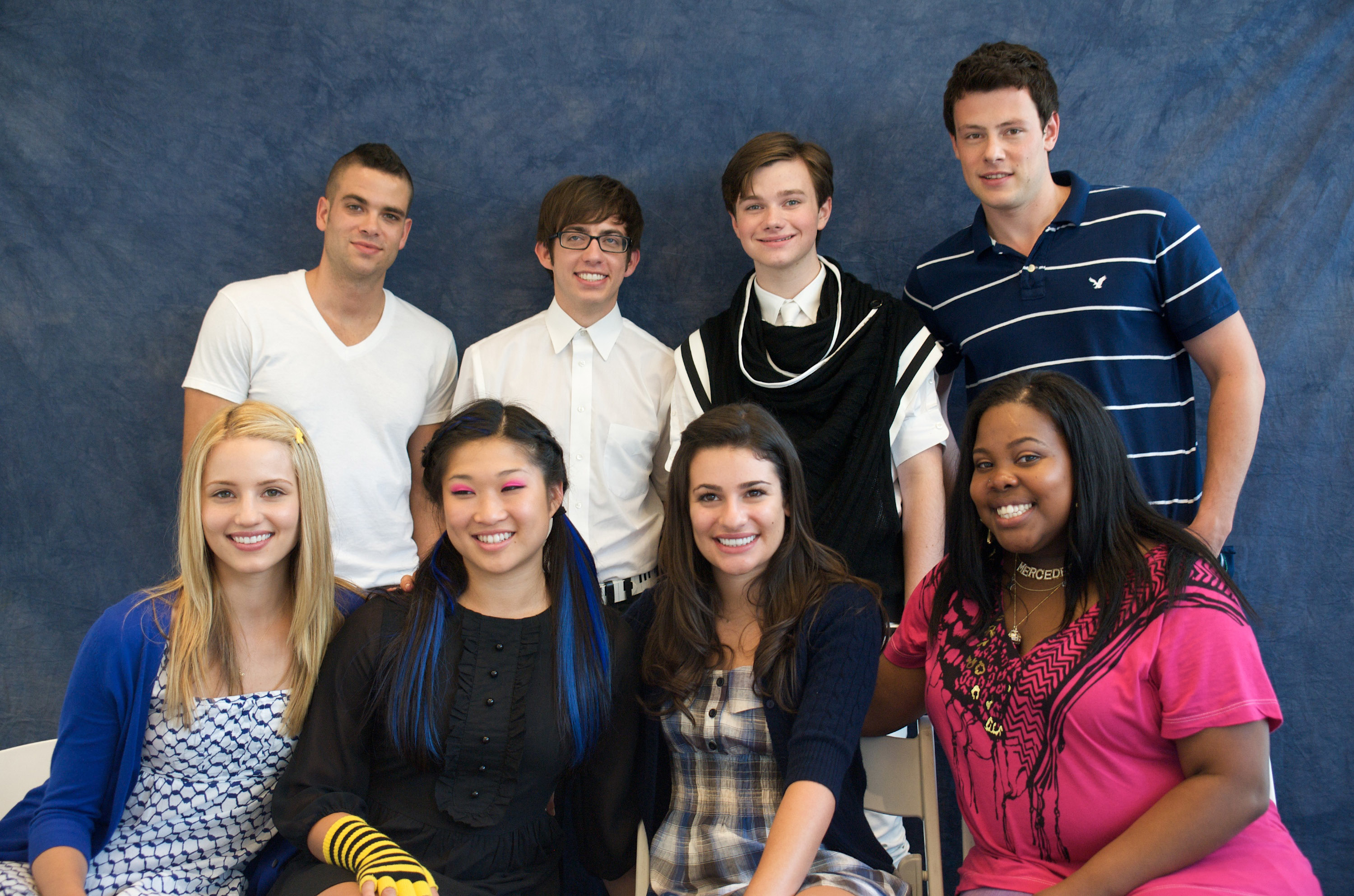 Mark Salling, Kevin McHale, Chris Colfer, Cory Monteith, Dianna Agron, Jenna Ushkowitz, Lea Michele, and Amber Riley are posing together, smiling