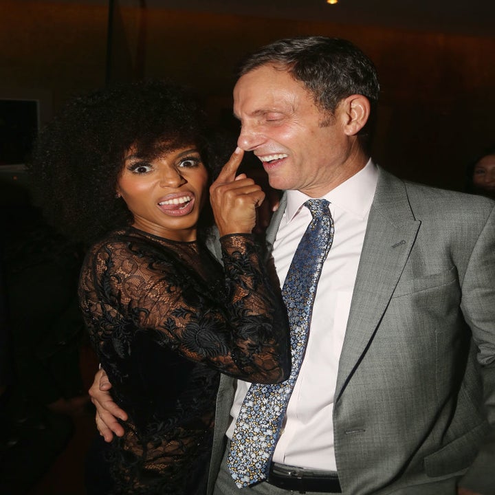 Kerry Washington in a lace dress playfully touches Tony Goldwyn's nose while posing together at an event