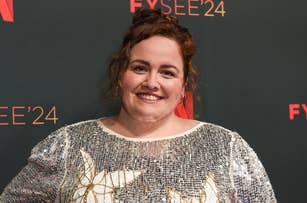 Jessica Gunning poses on the FYC 2024 red carpet in a sequined dress with floral patterns, smiling