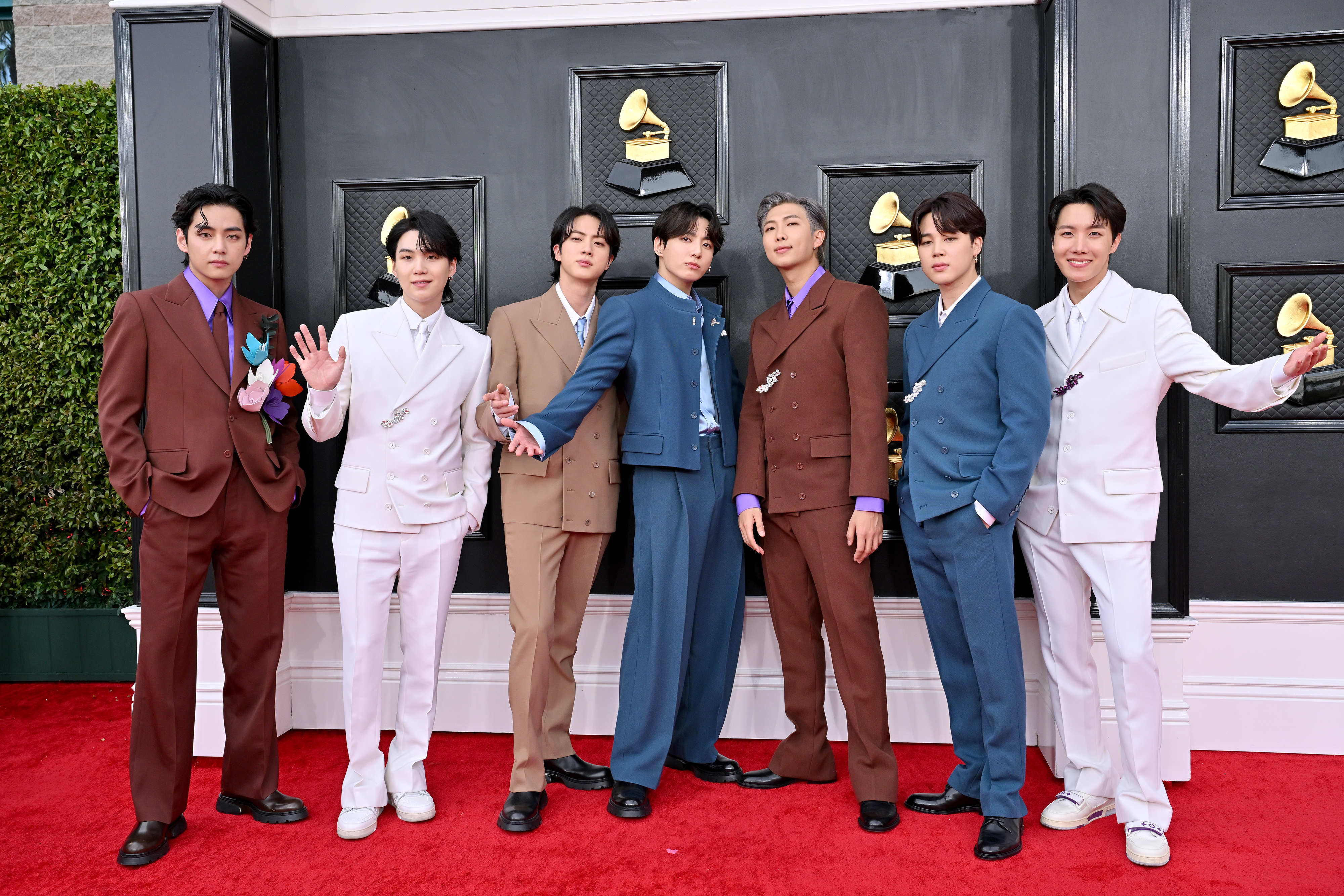 BTS members V, Suga, Jin, Jungkook, RM, Jimin, and J-Hope on the red carpet in coordinated suits at the Grammy Awards