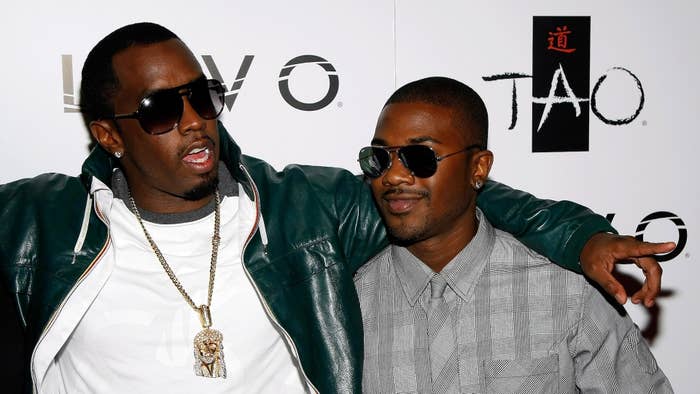 Sean &quot;Diddy&quot; Combs and Ray J on the red carpet; Diddy is in a green jacket and white shirt with a large necklace, Ray J is in a grey shirt, both wearing sunglasses