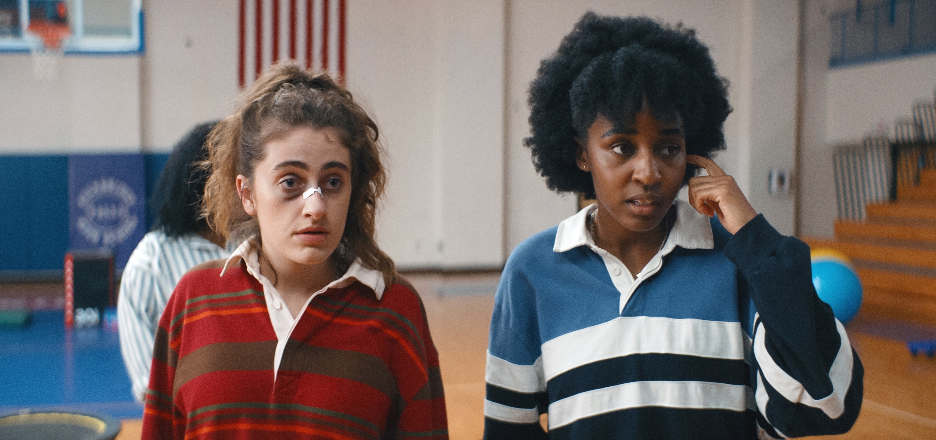 Rachel Sennott and Ayo Edebiri in a scene from the movie &quot;Bottoms,&quot; both wearing casual striped tops