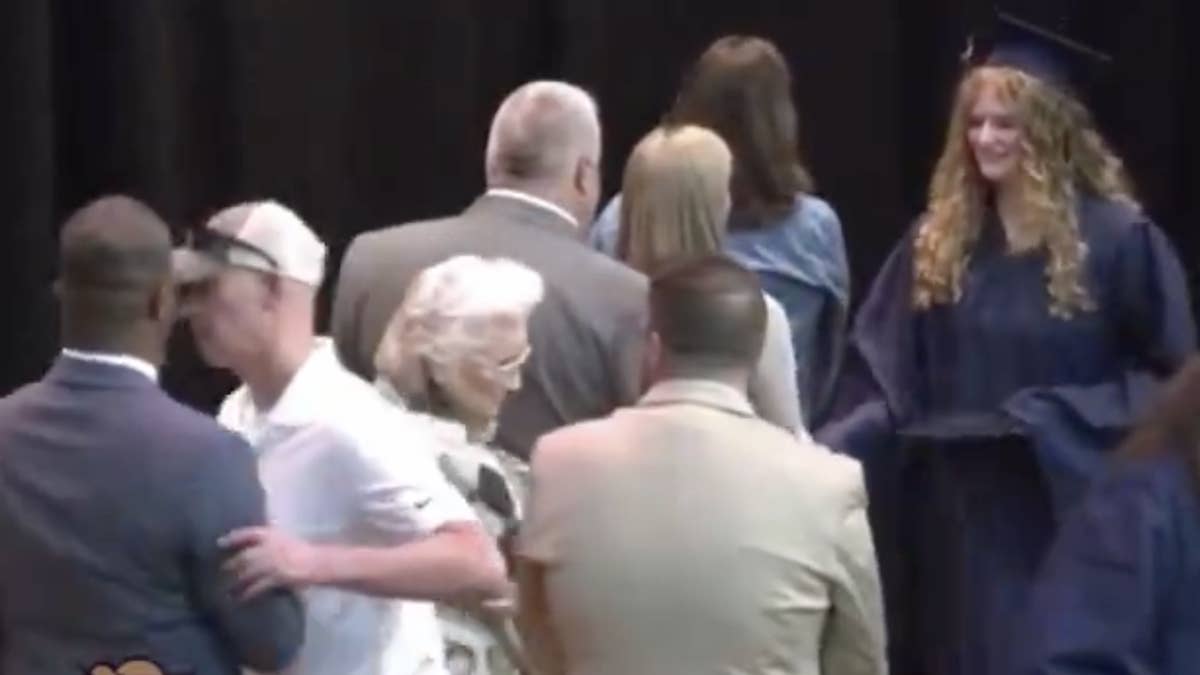 The man, who is white, was called out for being racist and not wanting the superintendent to shake his daughter's hand during the ceremony.