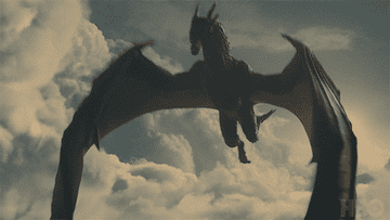 A dragon from HBO's &quot;Game of Thrones&quot; soars through the sky with wings spread wide against a backdrop of clouds