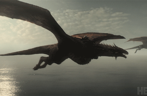 Two dragons from HBO's Game of Thrones flying over the ocean