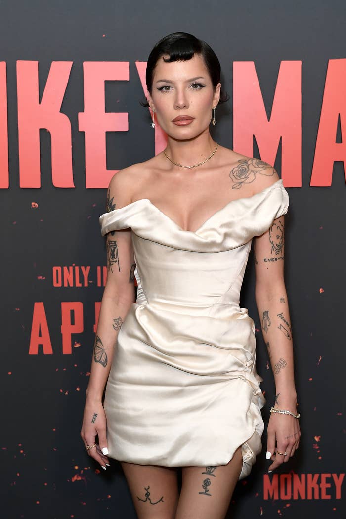 Halsey on the red carpet, wearing an off-the-shoulder corset dress with gathered details at the hip