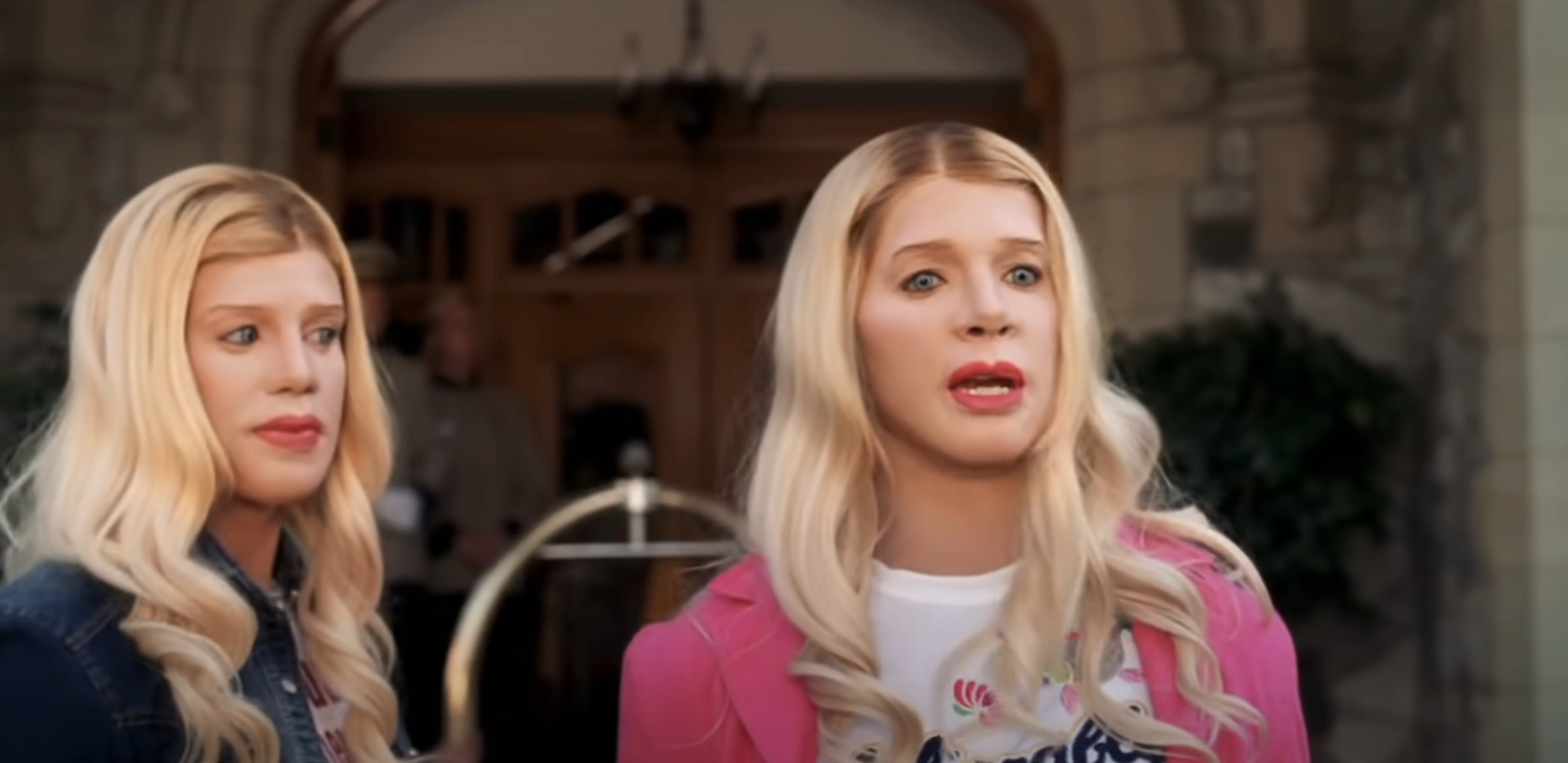 White Chicks characters, portrayed by Marlon Wayans and Shawn Wayans, dressed in casual women's clothing with long blonde wigs, standing outside a building