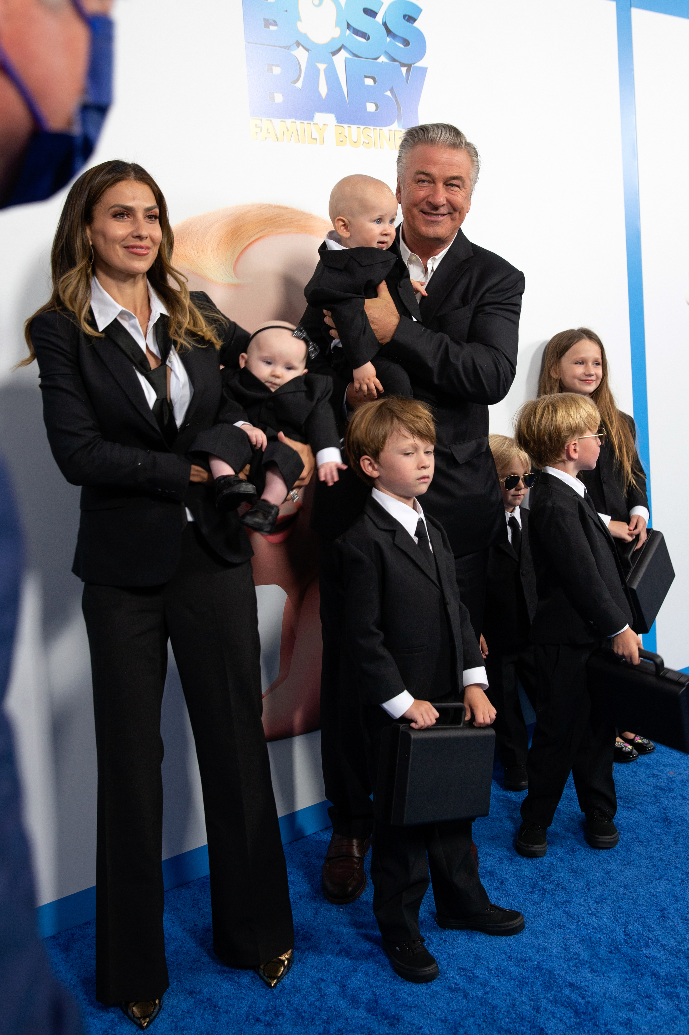 Alec Baldwin and Hilaria Baldwin are on the red carpet with their six children at the "Boss Baby: Family Business" premiere. They are all dressed in matching suits