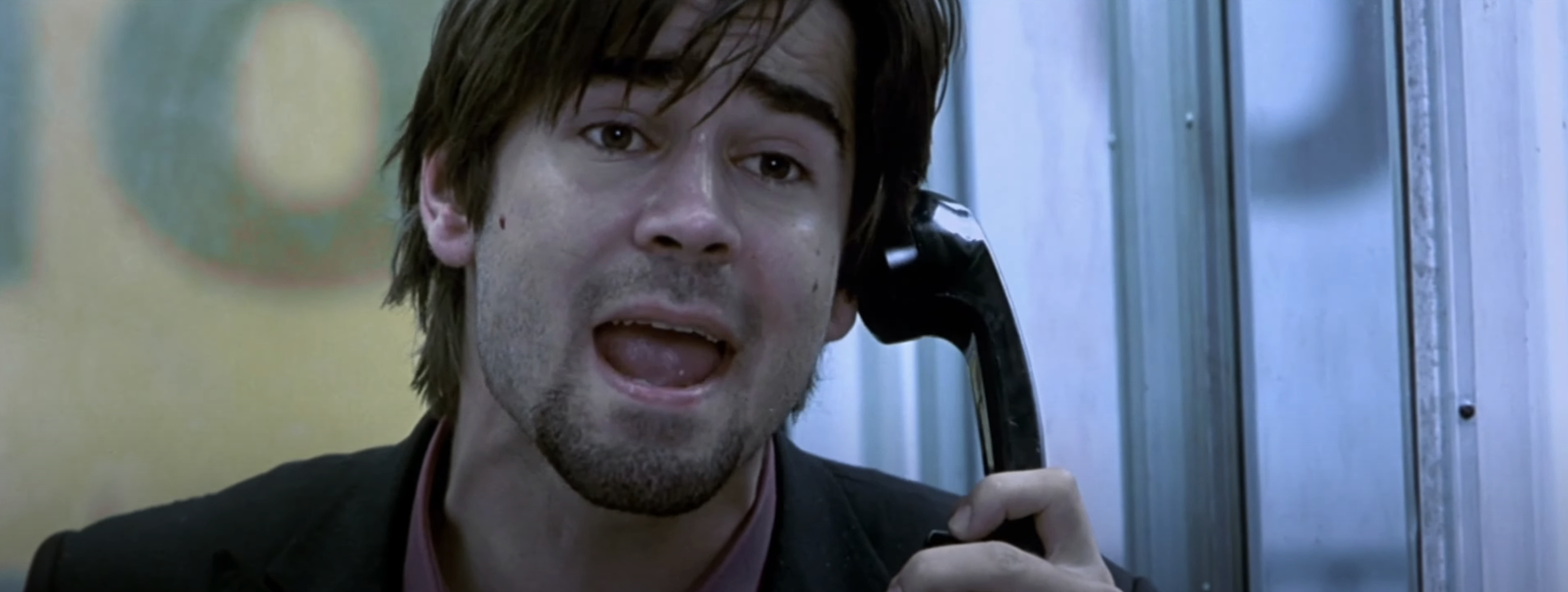 Colin Farrell in a tense scene, speaking into a phone booth