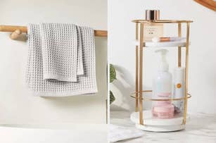 Gray waffle-knit towels hanging, and a gold and white bathroom organizer with skincare and beauty products, including lotion and a jar, on a marble countertop