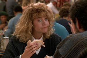 Meg Ryan in a scene from "When Harry Met Sally," holding a sandwich and talking to a man in a crowded diner