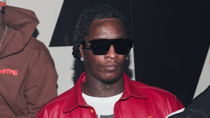 Young Thug wearing sunglasses and a leather jacket at an event