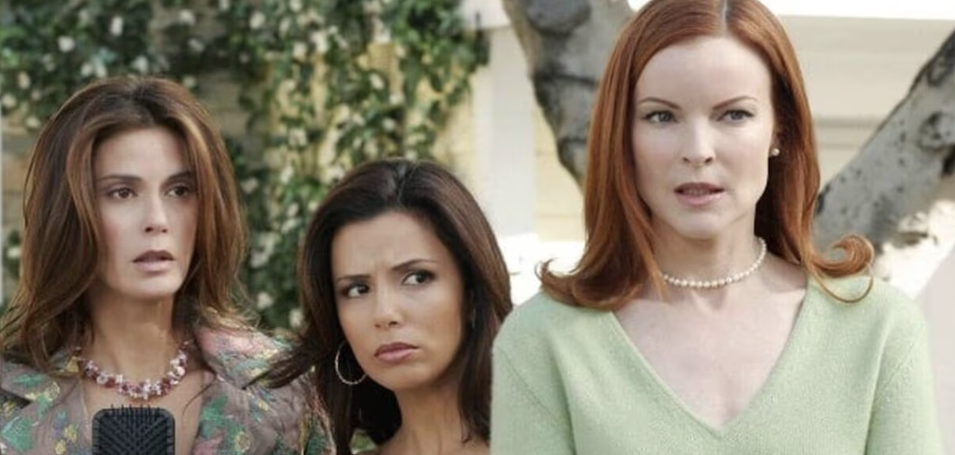 Teri Hatcher, Eva Longoria, and Marcia Cross stand outdoors, looking serious. They are dressed in stylish casual outfits and accessories