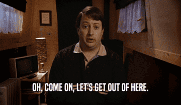 David Mitchell, in a dimly lit room, says, "Oh, come on, let's get out of here."