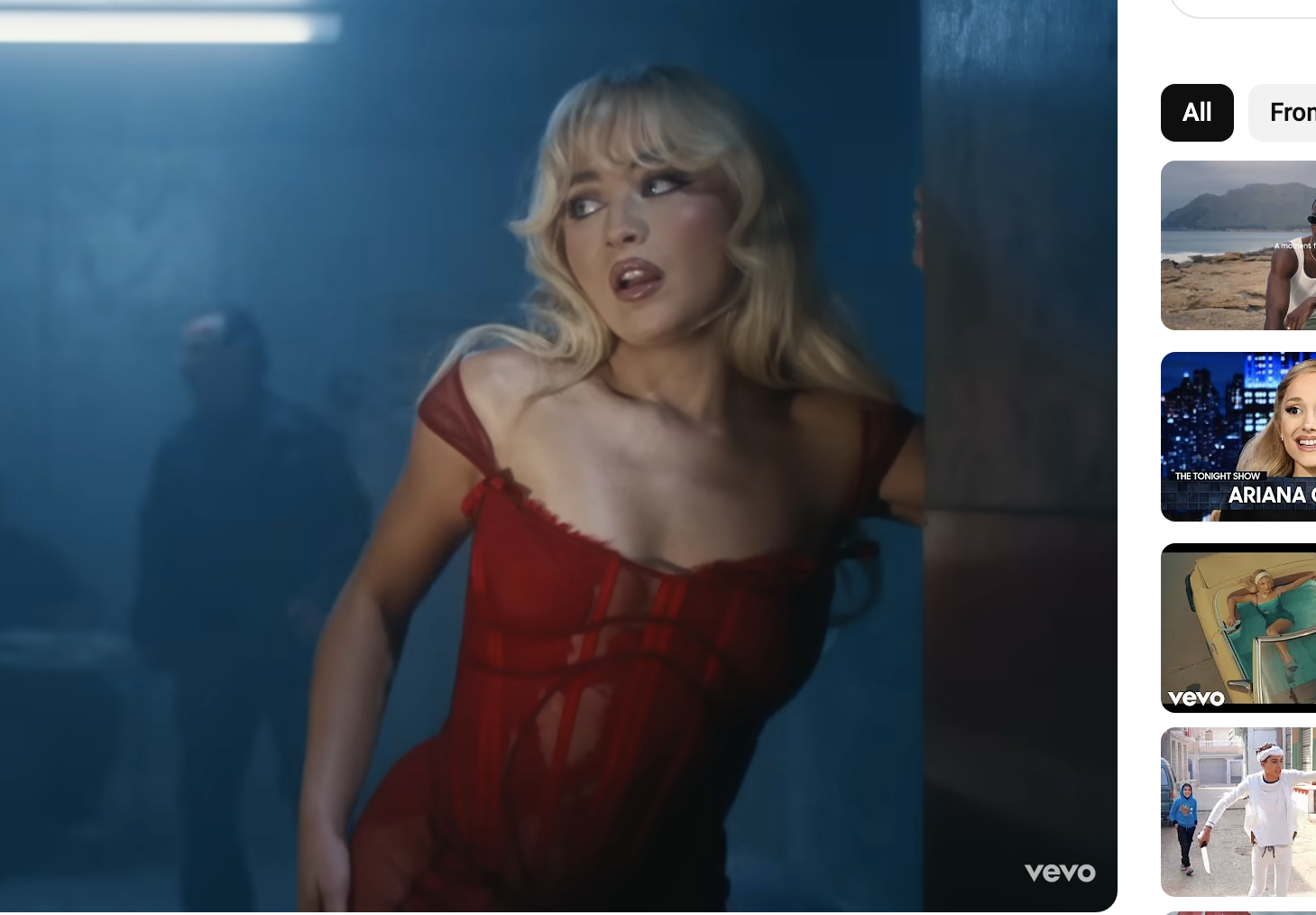 Sabrina Carpenter in a scene from her music video &quot;Please.&quot; She is performing with intensity, wearing a stylish dress