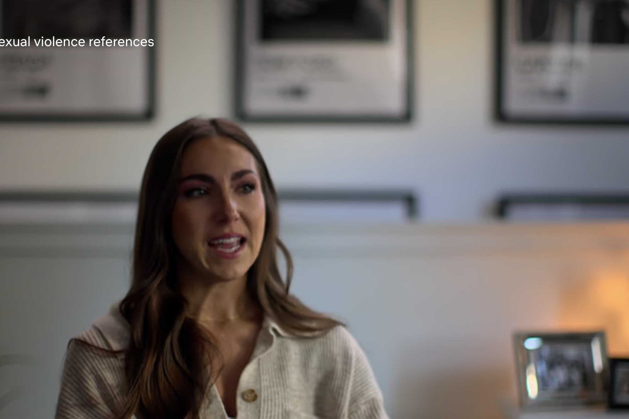 Ellen Durney speaks in an interview with a rating warning for sexual violence references displayed at the top left of the screen