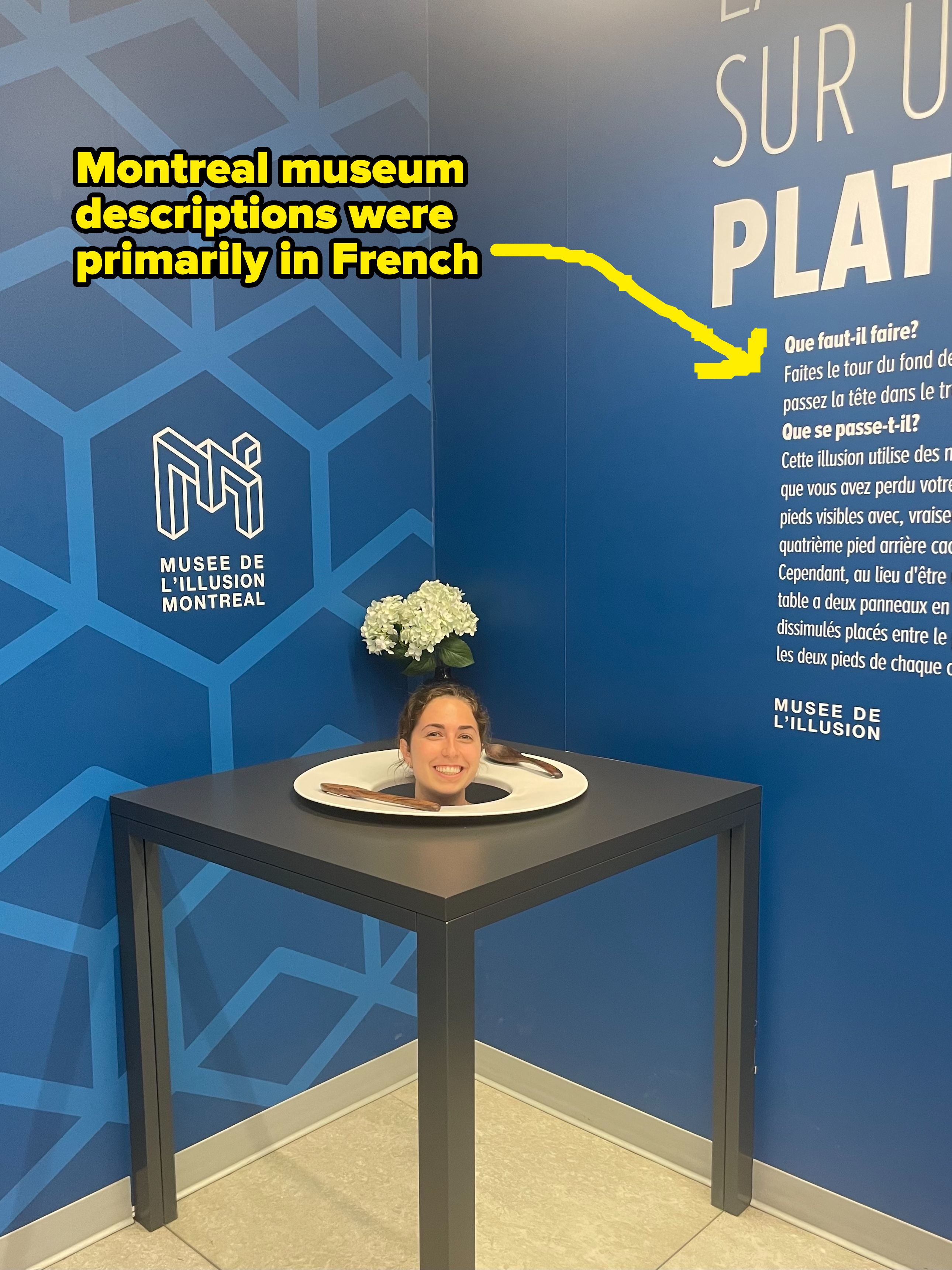 A woman appears headless in an illusion exhibit at the Museum of Illusions in Montreal. The exhibit's description, primarily in French, explains the illusion