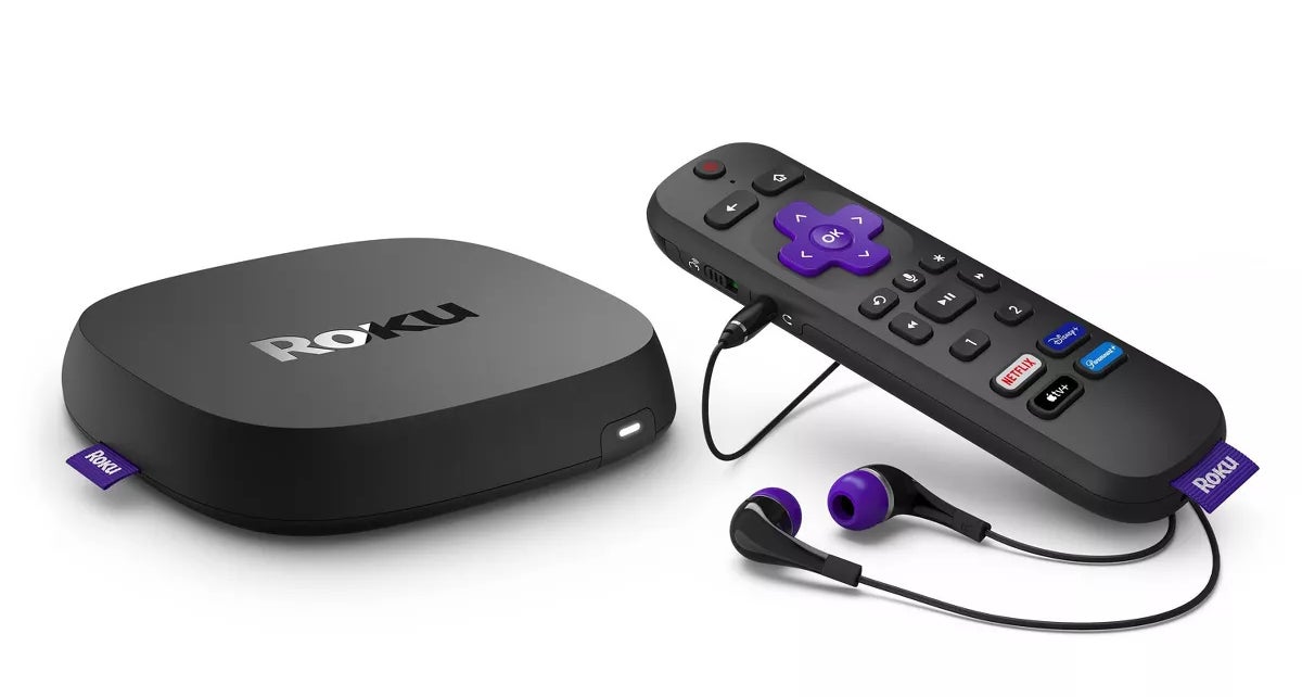 A Roku streaming device with a remote control and headphones