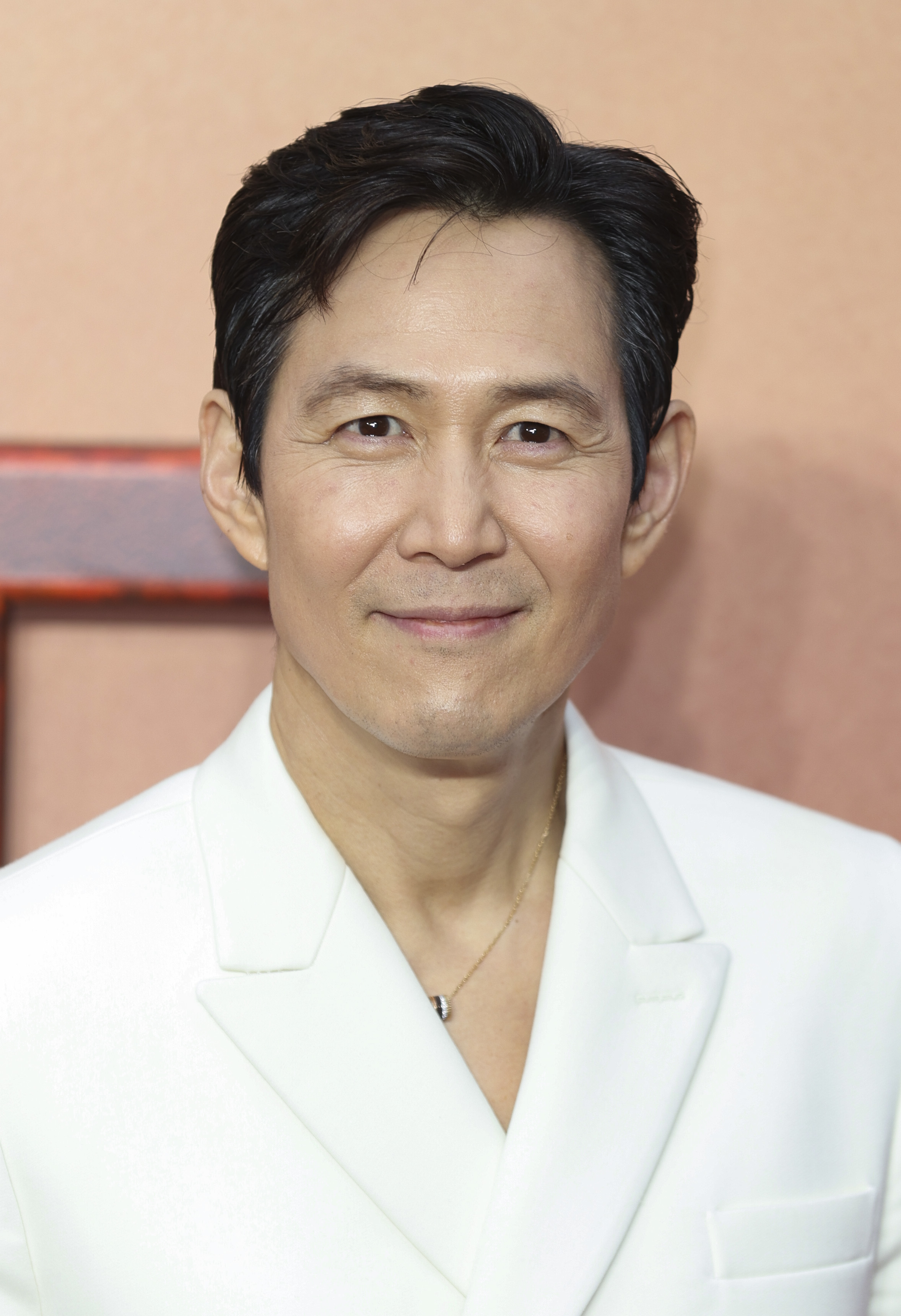 Lee Jung-jae in a white suit smiles at the camera at the UK premiere of &quot;Star Wars: The Acolyte&quot;