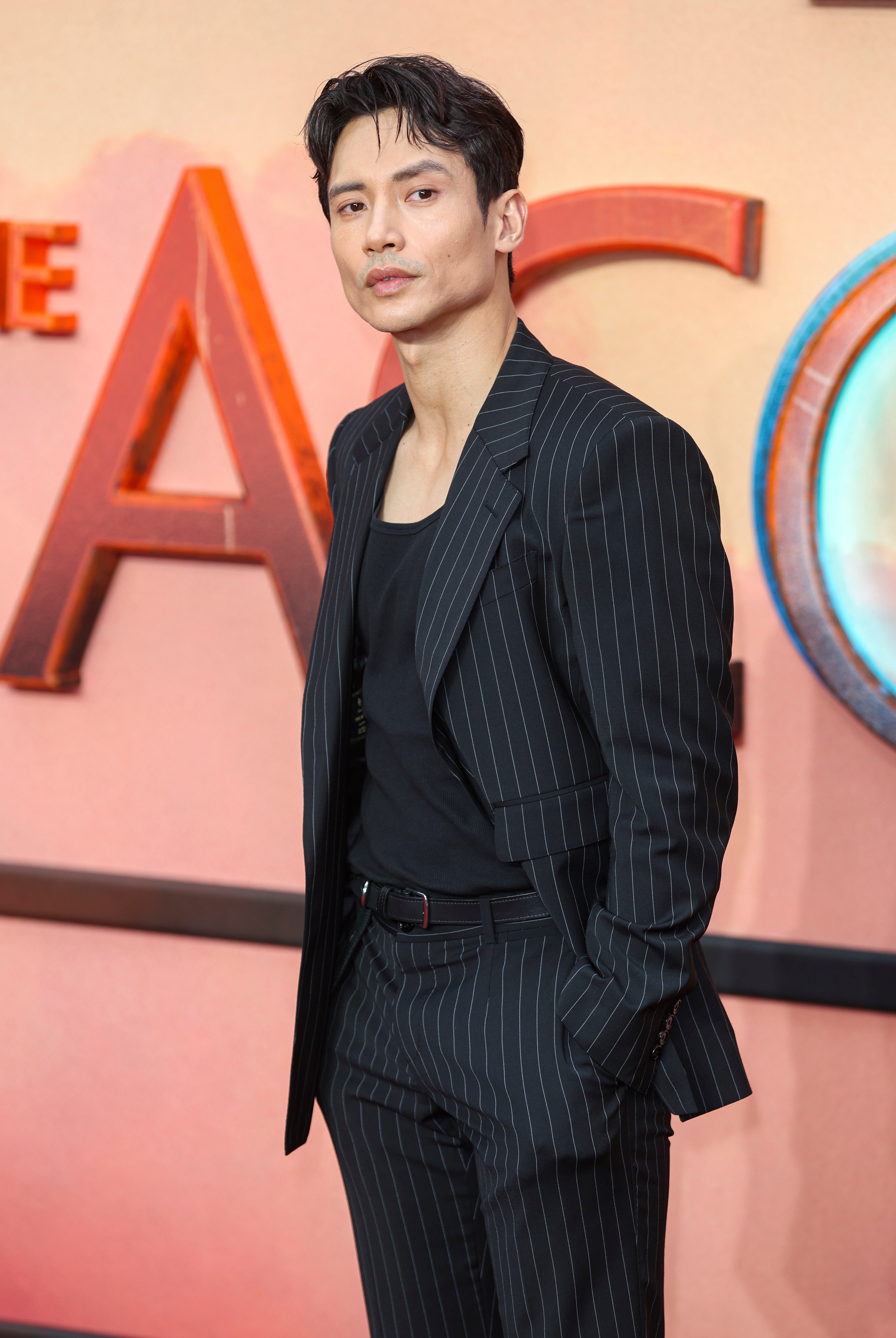 Manny Jacinto in a pinstripe suit at the UK premiere of &quot;Star Wars: The Acolyte&quot;