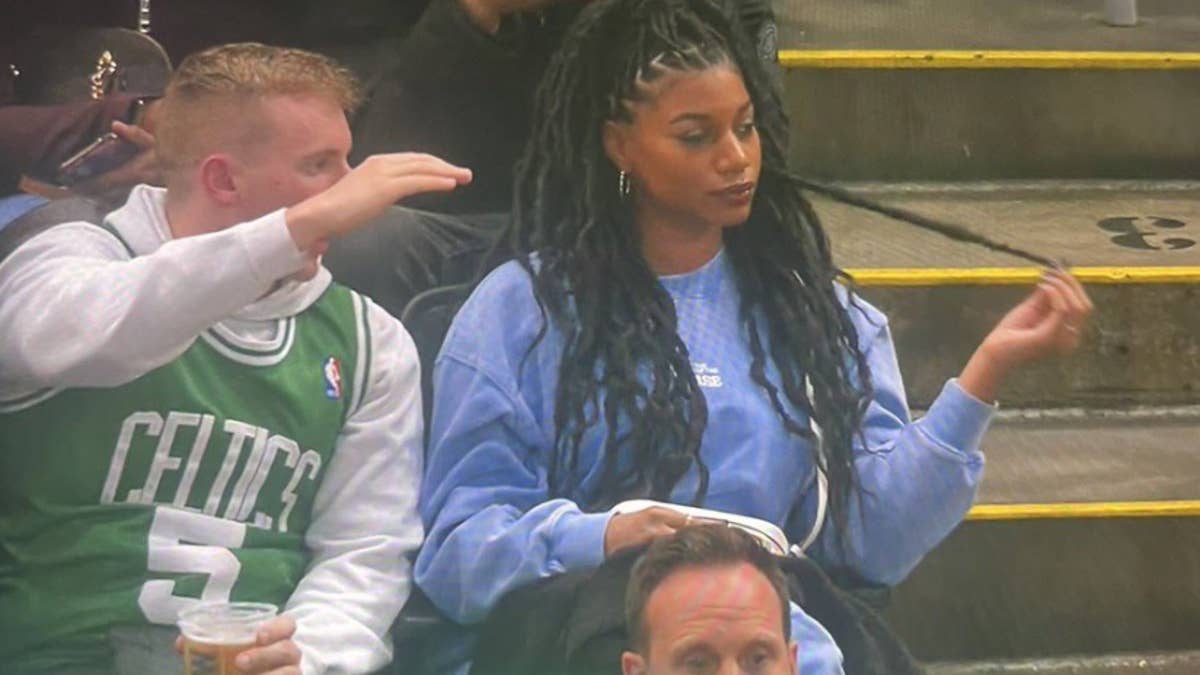 The 2023 photo features a Boston Celtics fan ranting to Rooks, who appears completely withdrawn from the conversation.