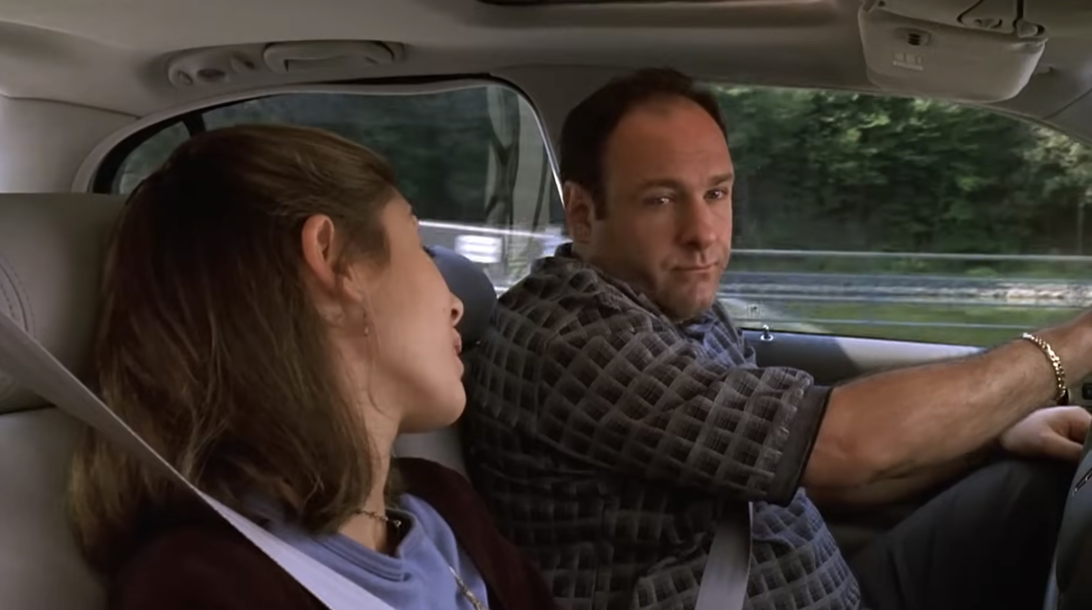 Jamie-Lynn Sigler and James Gandolfini in a car scene from &quot;The Sopranos,&quot; with Gandolfini wearing a patterned shirt and Sigler looking towards him