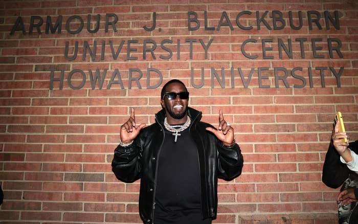 Sean &quot;Diddy&quot; Combs poses for a photo in front of the Armour J. Blackburn University Center at Howard University, wearing a leather jacket and sunglasses
