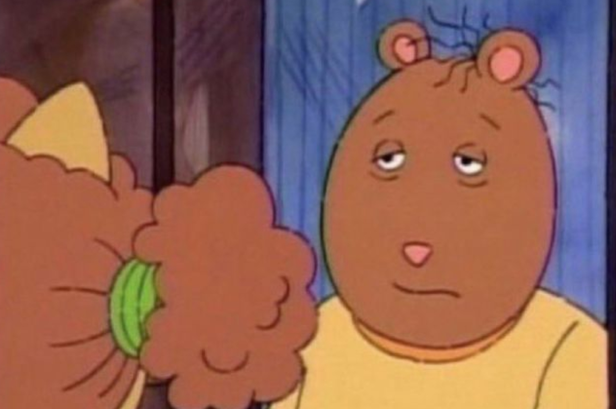 Arthur, a cartoon aardvark from the show &quot;Arthur,&quot; looks tired or unimpressed as his friend Buster, an unseen rabbit character, waves a hand or fist near him