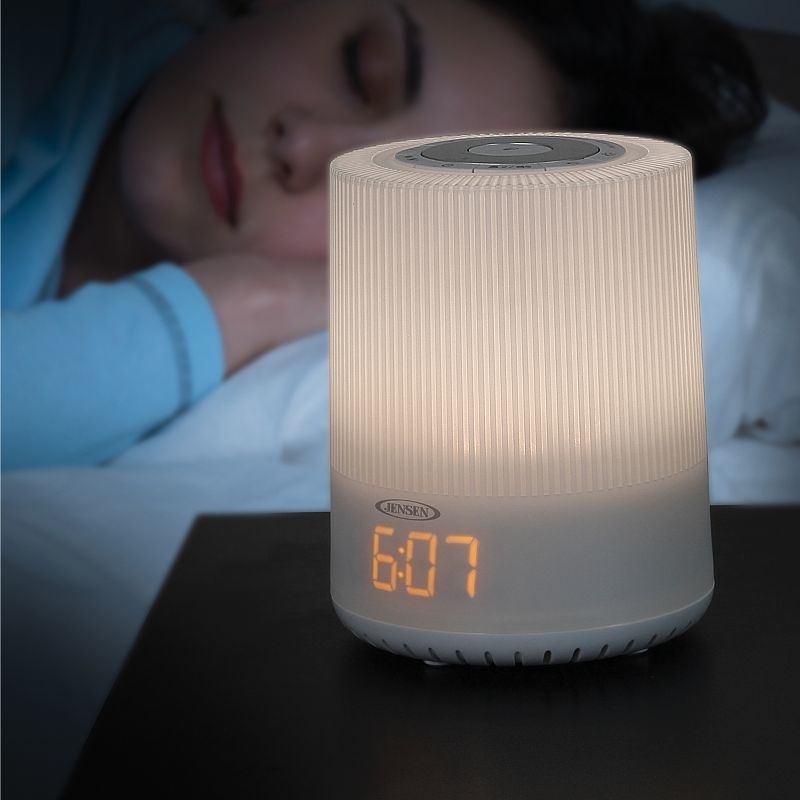 The alarm clock illuminated on a nightstand