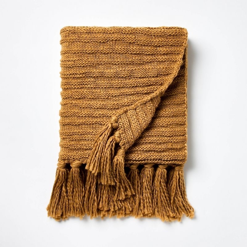 dark tan blanket with tassels