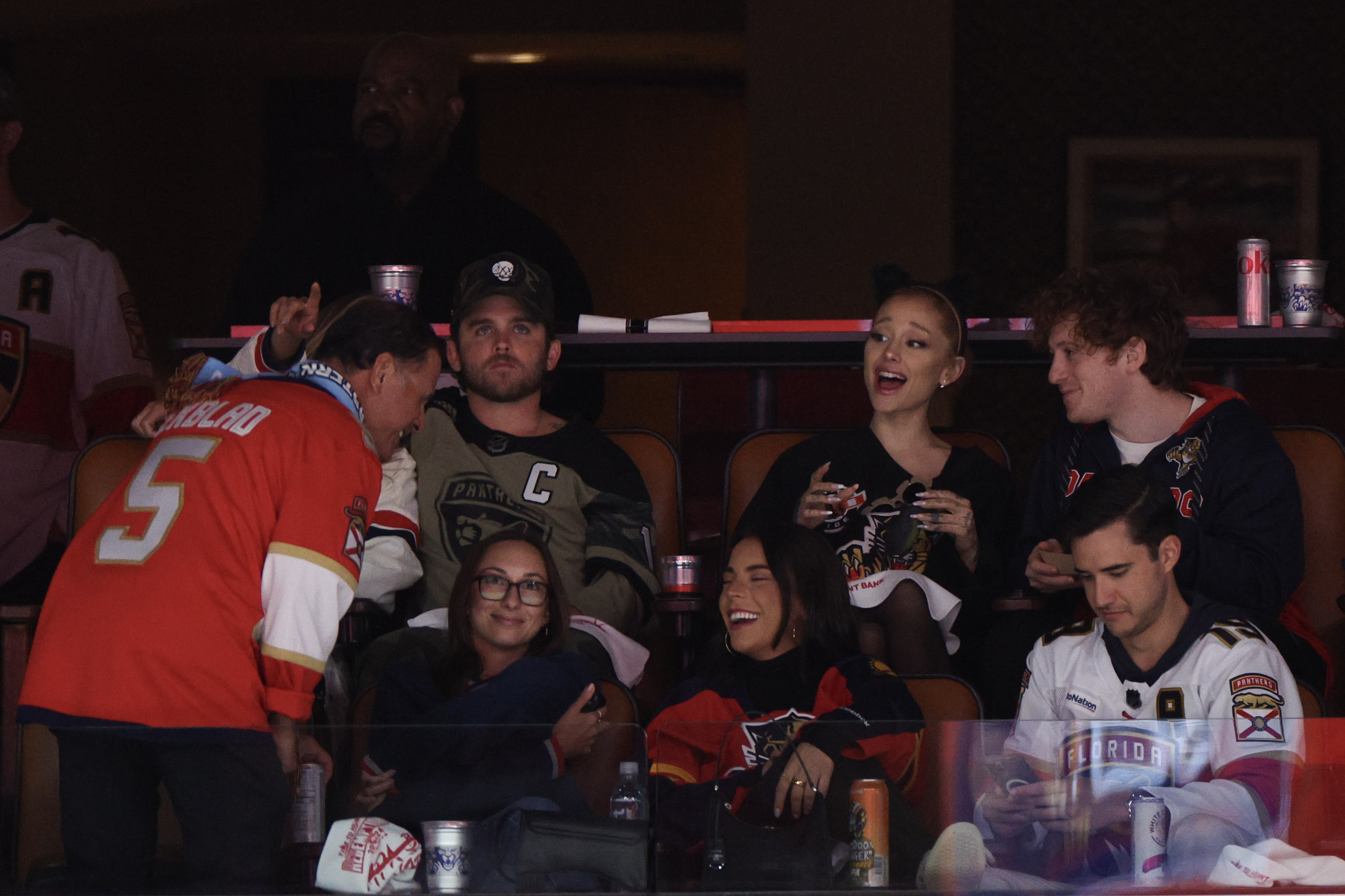 Wayne Gretzky, Paul Bissonnette, Ariana Grande, Lauren Jauregui, Machine Gun Kelly, G-Eazy, and another person enjoy a hockey game from box seats