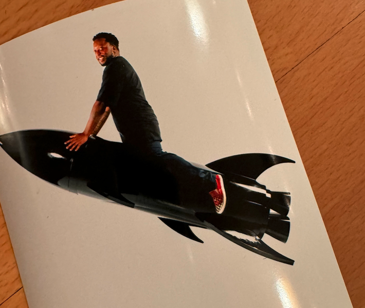 Mychal rides a rocket, appearing joyful