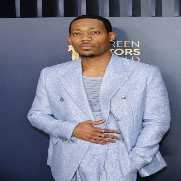 Tyler James Williams at the Screen Actors Guild Awards, wearing a double-breasted textured suit with a mesh shirt