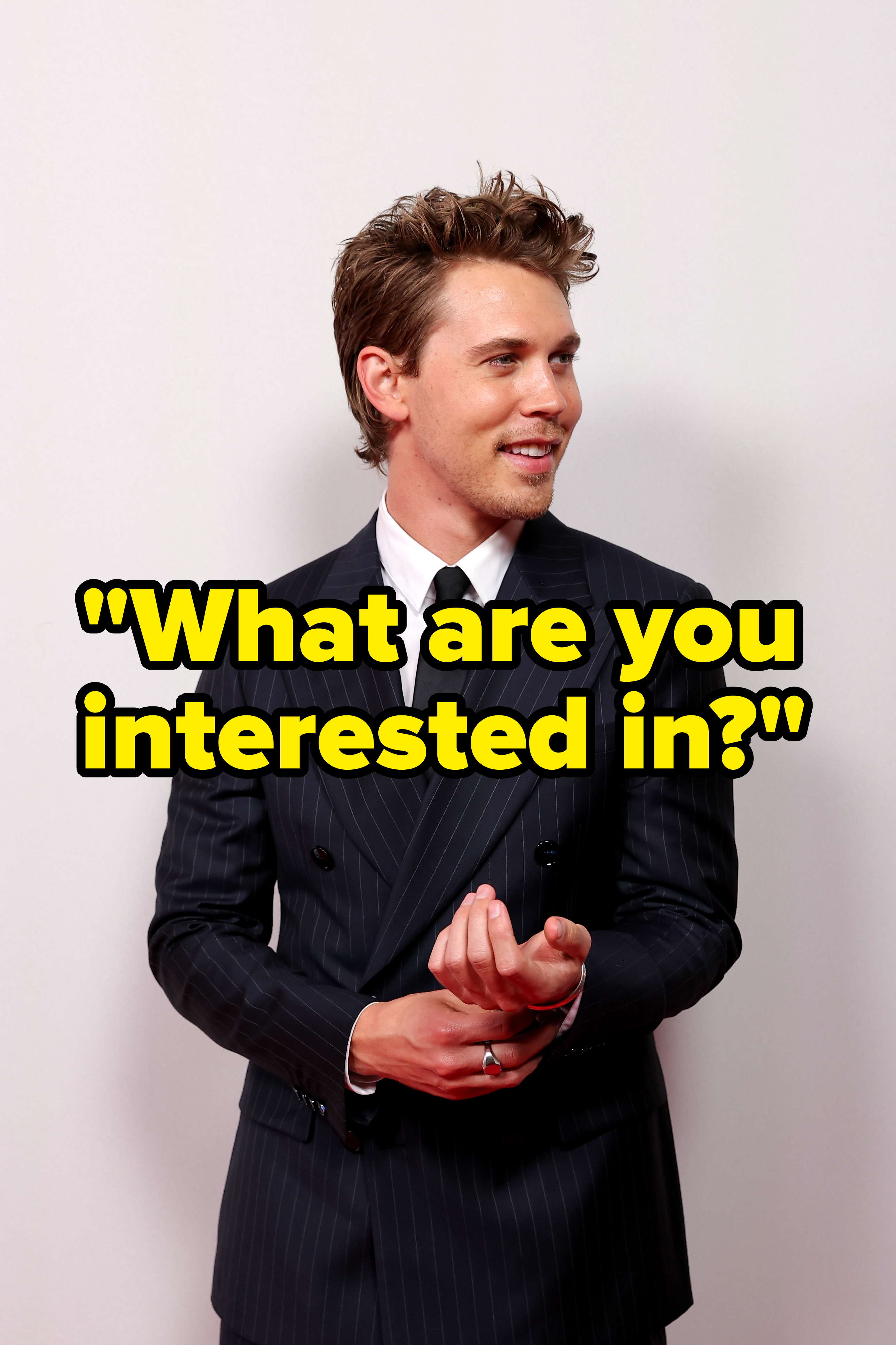 Austin Butler on red carpet in a pinstripe suit and black tie