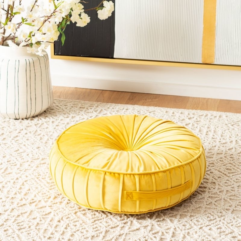 yellow pillow on a floor