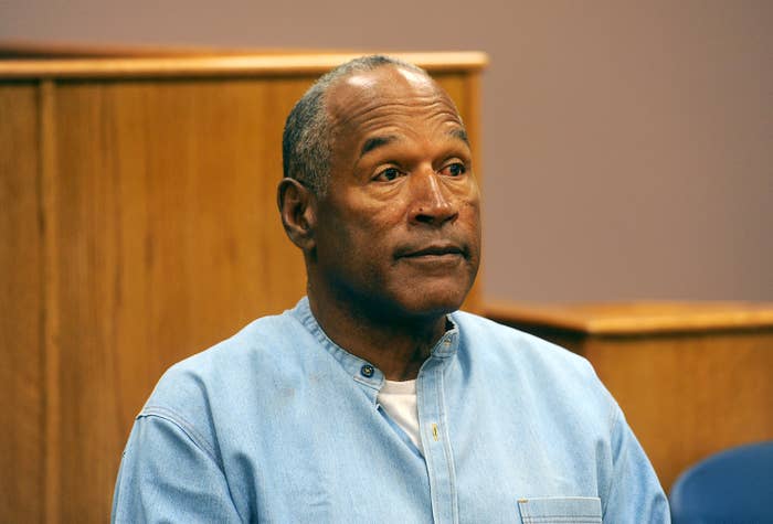 O.J. Simpson in a courtroom, wearing a light blue collared shirt