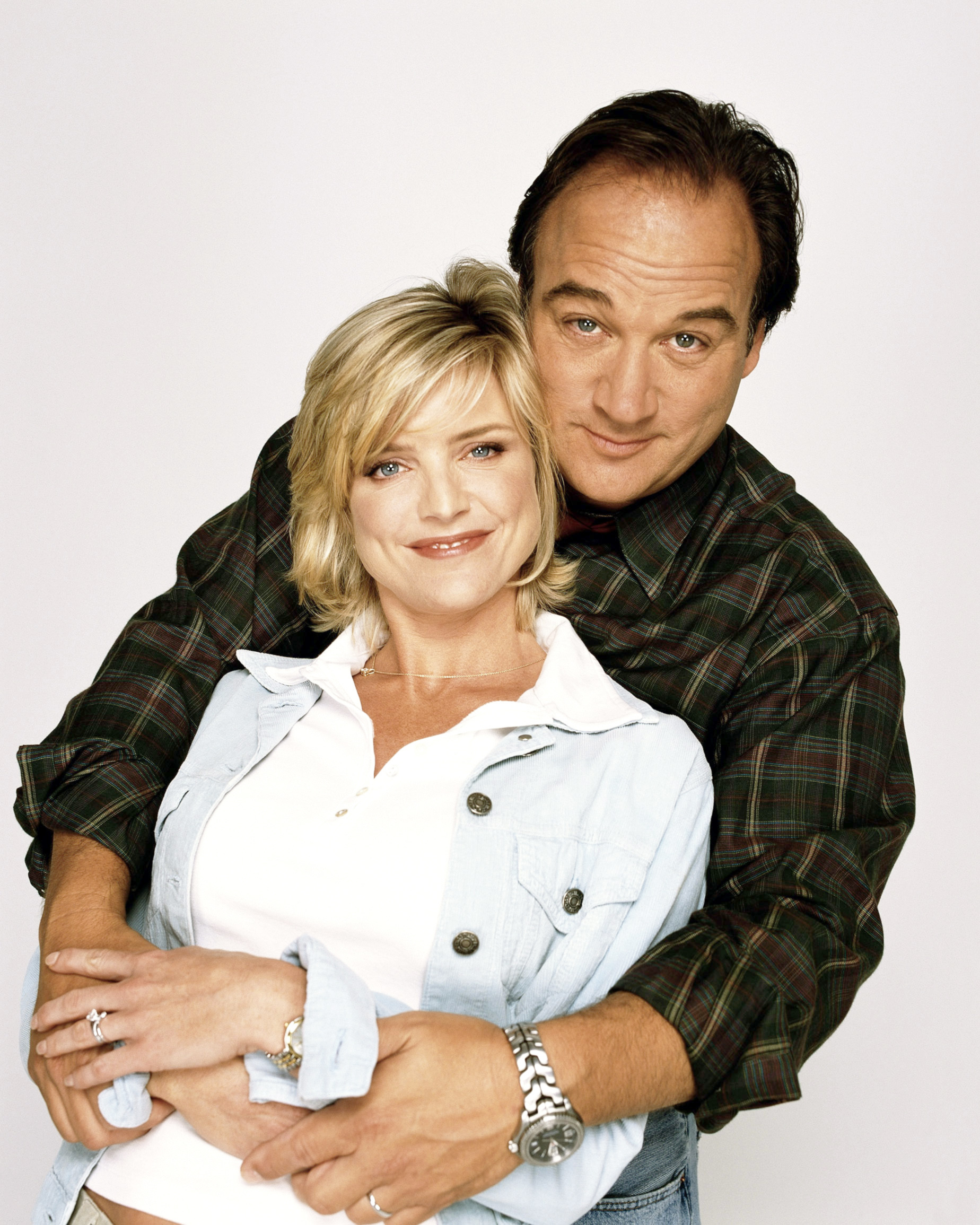 Courtney Thorne-Smith, Jim Belushi huding each other for a promo shot