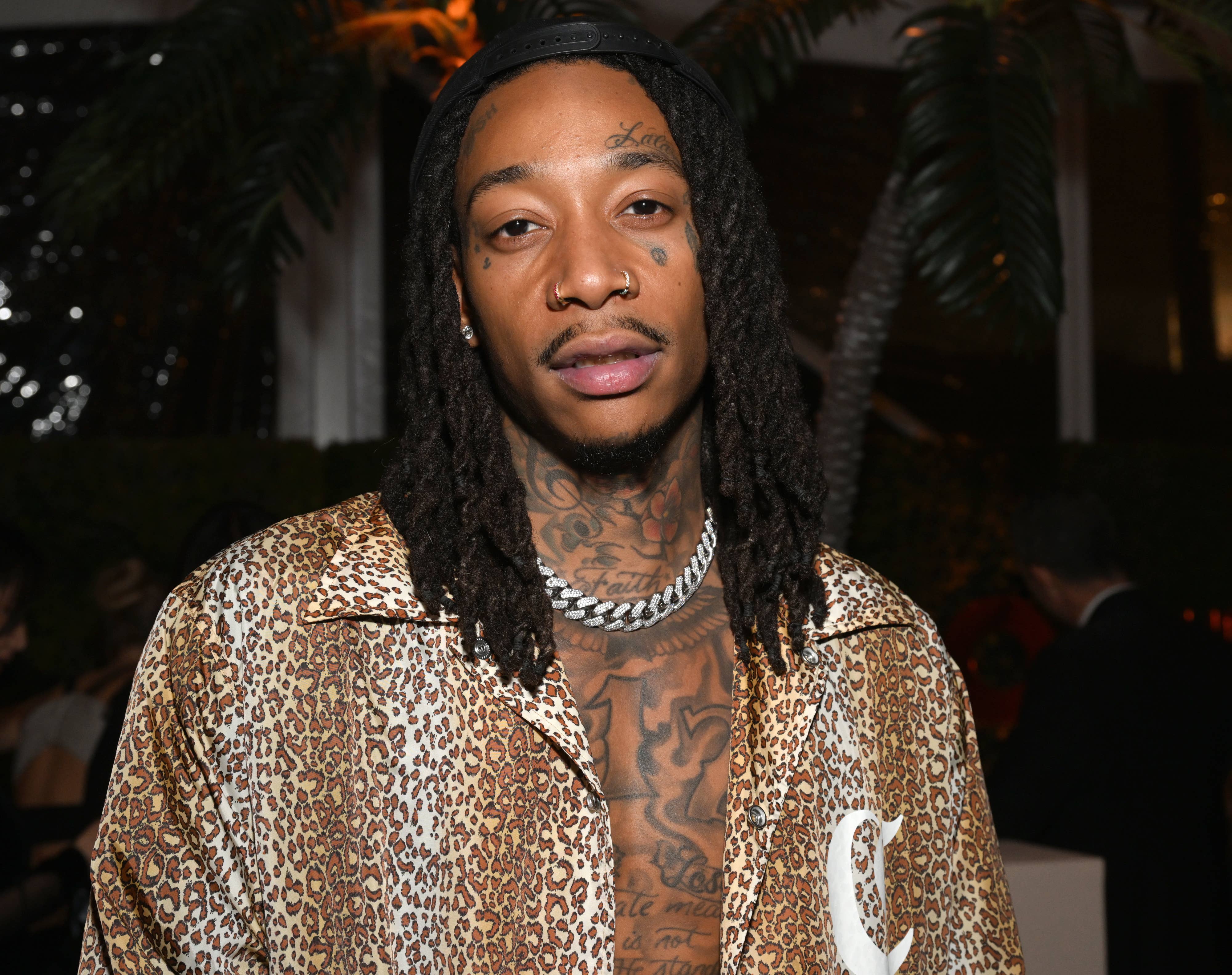 Wiz Khalifa wearing a leopard-print shirt and a chain necklace at an event