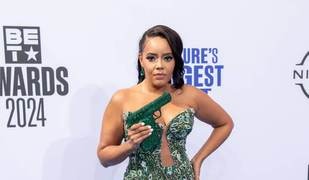 Angela Simmons in an intricately patterned, plunging dress with a statement handgun clutch on the red carpet at the BET Awards 2024