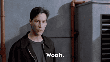 Keanu Reeves in a scene from The Matrix, looking surprised with the text “Woah.”